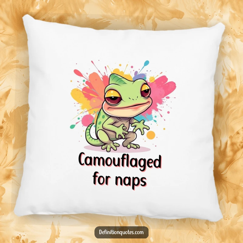 Funny, soft pillow featuring a sly chameleon character hilariously attempting to blend into a vibrant abstract paint splatter, adding artistic decor.