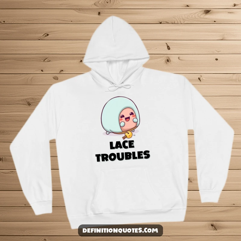 Funny Kawaii house slipper character comically tripping over its laces, depicted on a cozy, humorous hoodie. A funny gift.