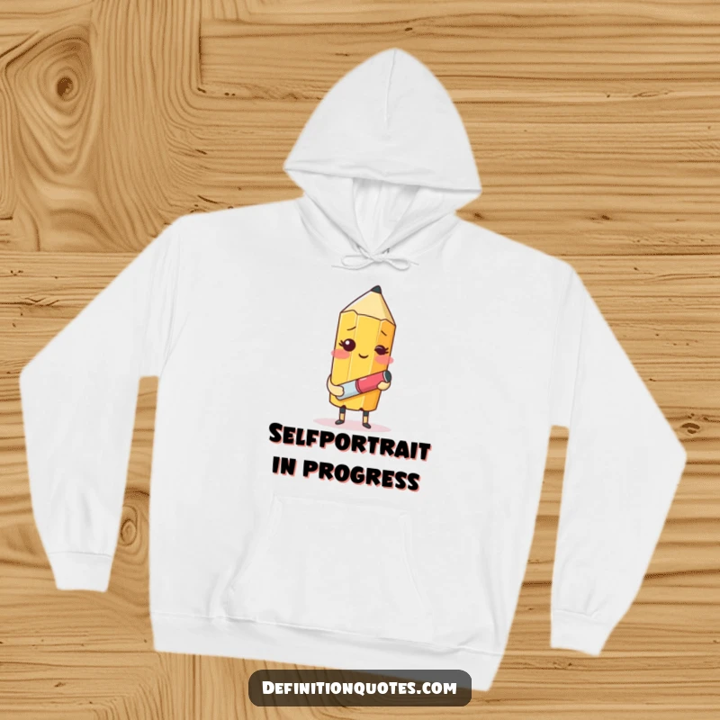 Funny hoodie showcasing a blushing pencil character with an eraser trying to draw itself, perfect for cozy creative sessions.