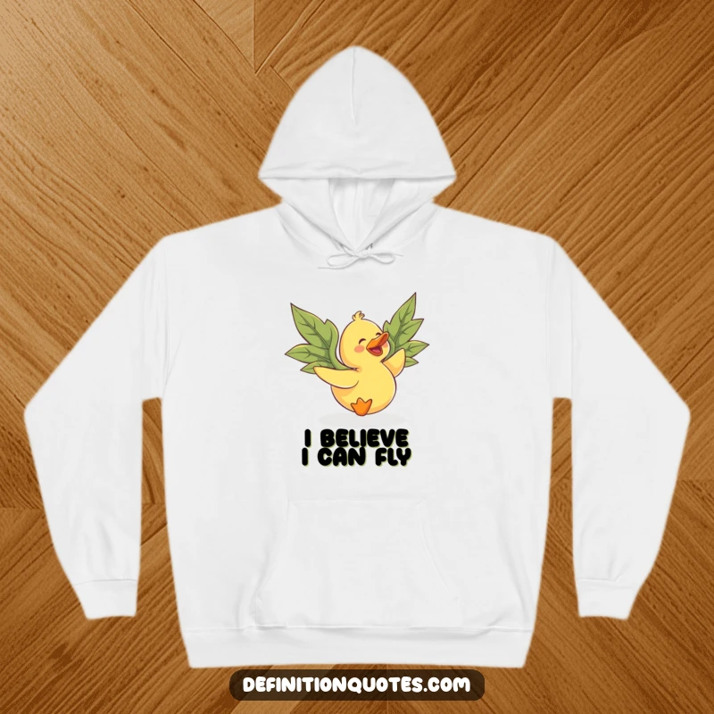 Funny rubber duck with large leaf wings, gleefully trying to fly, featured on a cozy hoodie.